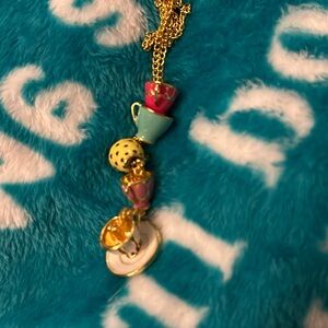 557 stacked tea cups in colors in gold tone